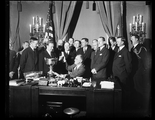 PRESIDENT PRESENTS REGATTA CUP. GEORGE REIS, WINNER OF THE RECENT PRESIDENT'S CUP REGATTA, RECEIVES HIS TROPHY FROM THE CHIEF EXECUTIVE. REIS IS THE ONLY MAN TO WIN THE CUP TWICE. HE WAS ACCOMPANIED ON THIS TRIP TO THE WHITE HOUSE, BY THE BOARD OF DIRECTORS OF THE PRESIDENT'S CUP REGATTA AND OTHER M