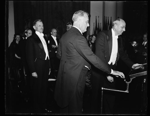 PRESIDENT ADDRESSES CRIME CONFERENCE. PRESIDENT ROOSEVELT ADDRESSES THE CRIME CONFERENCE, WHICH STARTED MONDAY UNDER THE SUPERVISION OF THE DEPARTMENT OF JUSTICE. FROM THE LEFT: PATRICK HURLEY, SECRETARY OF WAR UNDER HOOVER; PRESIDENT ROOSEVELT; AND ATTORNEY GENERAL HOMER CUMMINGS