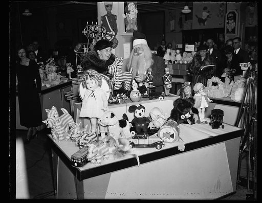 NO ELEPHANT TOYS FOR FIRST LADY. MRS. ROOSEVELT, ON A CHRISTMAS SHOPPING TOUR, HAD A HARD TIME CONVINCING SANTA CLAUS THAT SHE DID NOT WANT A TOY ELEPHANT, A SYMBOL OF THE REPUBLICAN PARTY, AS A CHRISTMAS PRESENT. SHE IS SHOWN HERE INSPECTING AN ASSORTMENT OF TOYS AT A WASHINGTON, D.C. DEPARTMENT ST
