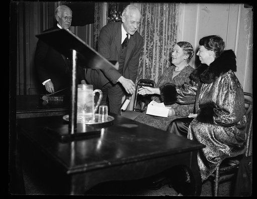 MRS. ROOSEVELT OPENS SLUM CLEARANCE MEETING. MRS. FRANKLIN D. ROOSEVELT IS GREETED BY NORMAN THOMAS AS THE FIRST LADY PREPARES TO OPEN THE NATIONAL PUBLIC HOUSING CONFERENCE AT THE WILLARD HOTEL IN WASHINGTON FRIDAY NIGHT. IN CENTER IS MARY KINGSBURY SIMKHOVITCH, NEW YORK, PRESIDENT OF THE NATIONAL 