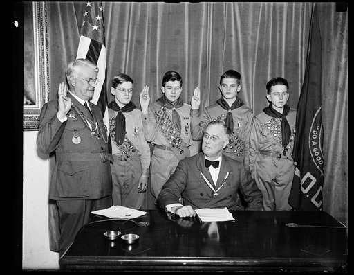 PRESIDENT GREETS SCOUTS. PRESIDENT ROOSEVELT, AT THE CONCLUSION OF THIS RADIO BROADCAST GREET BOY SCOUTS THROUGHOUT NATION, LISTENS WHILE THE OATH IS GIVEN. FROM THE LEFT: JAMES E. WEST, WASHINGTON, CHIEF SCOUT EXECUTIVE; SYDNOR HODGES OF TROOP 97; GEORGE KEPHART, TROOP 33; LLOYD STREET, TROOP 14; A