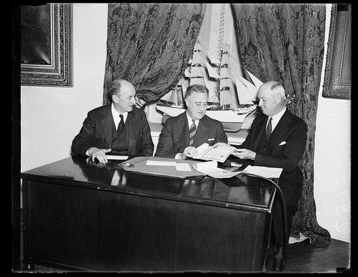 LOOKS LIKE A DEAL. PMG JAMES FARLEY, RIGHT, SEEMS PLEASED WITH THE PROSPECT OF MAKING HIS FIRST SALE OF 'BABY BONDS.' PRESIDENT ROOSEVELT, CENTER, FINALLY BOUGHT HALF A DOZEN, ONE FOR EACH OF HIS FIVE GRANDCHILDREN AND ONE FOR HIMSELF. SECRETARY HENRY DREN AND ONE FOR HIMSELF. SECRETARY HENRY MORGEN
