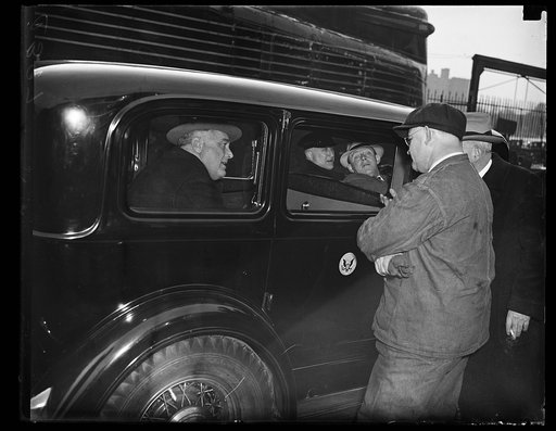 EXECUTIVE AND ENGINEER. PRESIDENT ROOSEVELT, SEATED IN HIS AUTOMOBILE IN WASHINGTON, BIDS GOODBYE TO ENGINEER F.G. HOUCHINS (PENNSYLVANIA RR) WHO HANDLED THE CONTROLS INTO WASHINGTON