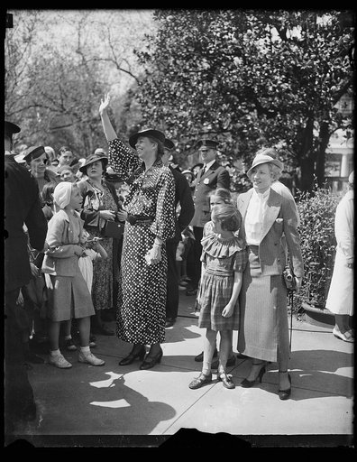 HERE'S THE HOSTESS. MRS. FRANKLIN D. ROOSEVELT, IN A BRIGHT NEW SPRING DRESS, MINGLES WITH THE THOUSANDS OF CHILDREN WHICH ARE HER GUESTS AT THE ANNUAL EGG ROLLING ON THE WHITE HOUSE LAWN FOLLOWING EASTER SUNDAY. IN THE PICTURE, FROM THE LEFT: MRS. FRANKLIN D. ROOSEVELT; AMY AND DIANA ROOSEVELT, DAU