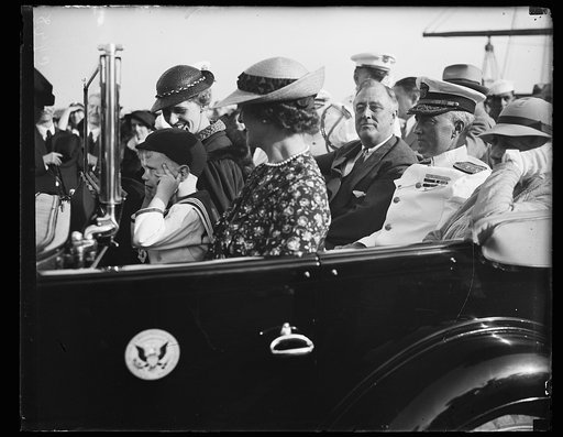 BYRD'S RECEPTION STARTS. REAR ADMIRAL RICHARD E. BYRD, POLAR EXPLORER, LEAVES THE NAVY YARD WITH PRESIDENT ROOSEVELT AMID THE ROAR OF SALUTING GUNS. MRS. ANNA DALL BOETTIGER, WITH HER CHILDREN SISTIE AND BUZZIE, ARE TO THE LEFT. SEATED WITH HER IS MRS.BYRD, WIFE OF THE EXPLORER. IN THE REAR SEAT ARE