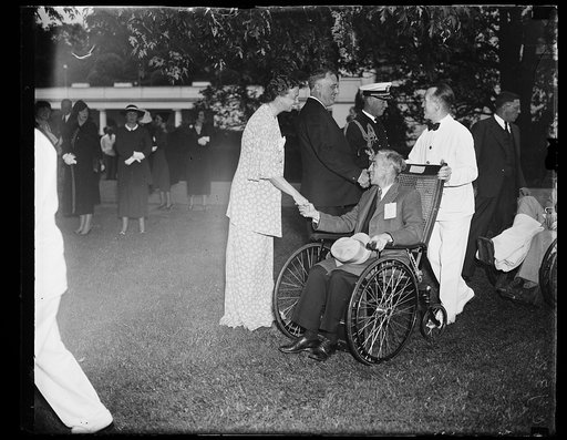 WAR VICTIMS RECEIVED BY PRESIDENT. PRESIDENT AND MRS. ROOSEVELT STAND ON THE WHITE HOUSE LAWN AS A STREAM OF WOUNDED VETERANS, SOME IN WHEEL CHAIRS, SOME ON CRUTCHES, PASS THE COMMANDER-IN-CHIEF FOR A WORD OF GREETING. FROM THE LEFT: MRS. ROOSEVELT, THE PRESIDENT, AND CAPT. WILSON BROWN, WHITE HOUSE