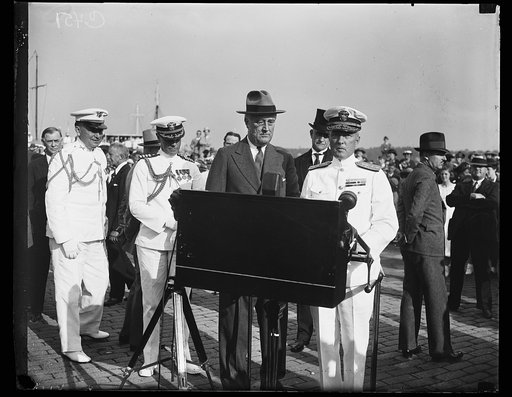 GREETINGS FROM BYRD. REAR ADMIRAL RICHARD E. BYRD, RIGHT, DELIVERS HIS SPEECH TO THE COUNTRY AS HE IS GREETED BY PRESIDENT ROOSEVELT IN WASHINGTON. FROM THE LEFT: PRESIDENT ROOSEVELT, GOV. GEORGE C. PEERY OF VIRGINIA, AND REAR ADMIRAL BYRD