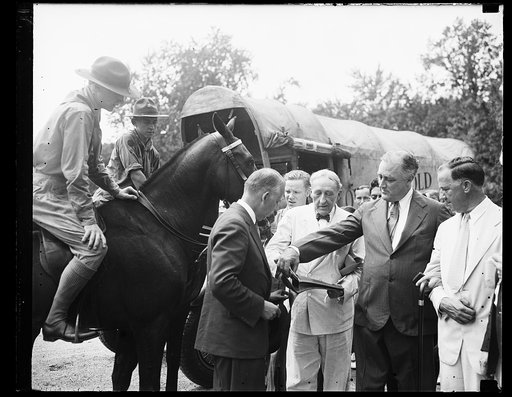 RE-RIDE OREGON TRAIL TO WHITE HOUSE. BOY SCOUTS ARRIVE AT THE WHITE HOUSE AS THEY COMPLETE THE TRIP FROM SACRAMENTO, CALIFORNIA, OVER THE OLD PONY EXPRESS TRAIL FIRST RIDDEN 75 YEARS AGO. MAJ. ARTHUR PROCTER OF NEW YORK, HANDS A PACKET OF LETTER TO PRESIDENT ROOSEVELT. THE LETTERS WERE WRITTEN BY GO