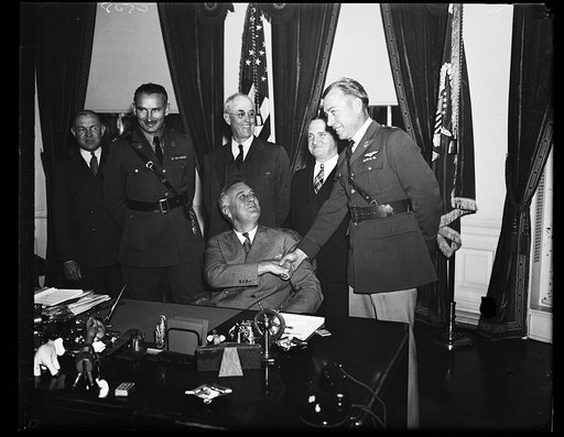 PRESIDENT GREETS STRATO FLYERS. PRESIDENT ROOSEVELT GREETS THE ARMY FLIERS WHO PILOTED THE STRATO BALLOON TO A NEW ALTITUDE RECORD OF 74,000 FEET IN SOUTH DAKOTA ON THE U.S. AIR CORP-NATIONAL GEOGRAPHIC FLIGHT. FROM THE LEFT: CAPT. ALBERT STEVENS; GEN. MALIN CRAIG, CHIEF OF STAFF; MAJ. GEN. OSCAR WE