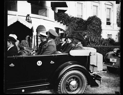 PRESIDENTIAL FAMILY LEAVES FOR ARLINGTON. PRESIDENT ROOSEVELT AND HIS FAMILY LEAVE THE WHITE HOUSE FOR ARLINGTON CEMETERY WHERE HE DELIVERED AN ARMISTICE DAY ADDRESS AT THE TOMB OF THE UNKNOWN SOLDIER. IN THE REAR SEAT, FROM THE LEFT: JOHN ROOSEVELT, THE SON; MRS. ROOSEVELT AND THE PRESIDENT