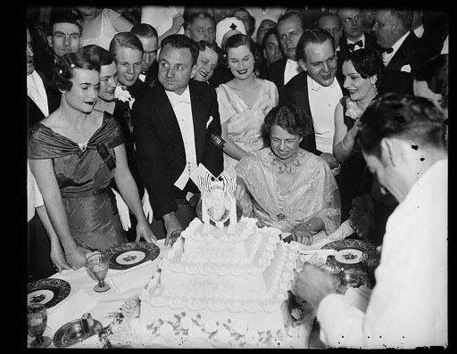 CUTS CAKE FOR PRESIDENT. WASHINGTON, D.C. MRS. FRANKLIN ROOSEVELT CUTS A CAKE AT THE PRESIDENT'S BIRTHDAY BALL AT THE SHOREHAM HOTEL IN WASHINGTON. THE PRESIDENT DID NOT ATTEND
