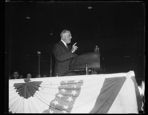 PRESIDENT SMILES. BALTIMORE, MD, APRIL 13. PRESIDENT ROOSEVELT ASSUMED A SERIOUS POSE AS HE PLUNGED DEEPER INTO HIS OPENING SPEECH OF THE 1936 CAMPAIGN. HIS SPEECH ON THE AVENUES TO THE YOUNG DEMOCRATS WAS DELIVERED IN BALTIMORE FOLLOWING A TORCH-LIGHT PARADE
