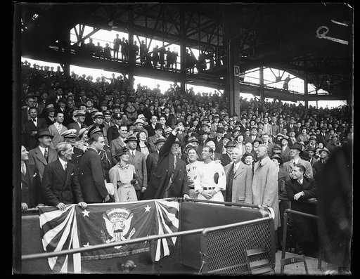PRESIDENT TOSSES OUT FIRST BALL. WASHINGTON, D.C. APRIL 14. THE LID WAS OFFICIALLY PRIED OFF THE 1936 BASEBALL SEASON IN WASHINGTON TODAY WHEN PRESIDENT ROOSEVELT TOSSED OUT THE FIRST BALL TO START HOSTILITIES BETWEEN THE SENATORS AND THE NEW YORK YANKEES. IN THIS PHOTOGRAPH, L TO R: SECRETARY MARVI