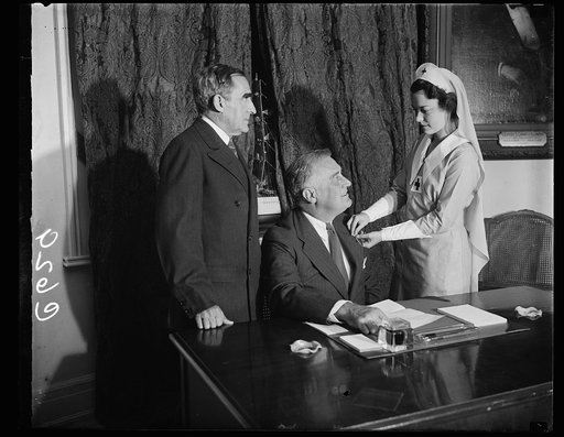 CHIEF EXECUTIVE ANSWERS RED CROSS ROLL CALL. WASHINGTON, D.C. OCTOBER 20. PRESIDENT ROOSEVELT ANSWERED THE AMERICAN RED CROSS 1937 ROLL CALL TODAY AND WAS ENROLLED BY MISS HEBE REYNOLDS, OF THE DISTRICT OF COLUMBIA RED CROSS CHAPTER, AT THE WHITE HOUSE. MISS REYNOLDS IS THE DAUGHTER OF MAJ. GEN. CHA