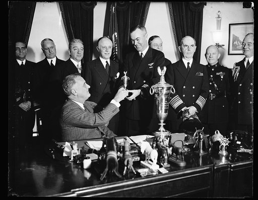 PRESIDENT AWARDS SCHIFF TROPHY, WASHINGTON, D.C. JANUARY 14. PRESIDENT ROOSEVELT PRESENTING THE SCHIFF TROPHY FOR 1936 TO COMMANDER ANDREW C. McFALL, U.S.N., COMMANDER OF THE TRAINING SQUADRON 8 D 5 JUDGED TO BE THE MOST EFFICIENTLY OPERATED SQUADRON IN THE U.S. NAVAL AVIATION LAST YEAR. THE HERBERT