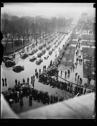 THE RAIN DIDN'T MEAN A THING TO THE STATE GOVERNORS AS THEY RODE IN CLOSED CARS IN THE INAUGURAL PARADE TODAY. WASHINGTON D.C. JANUARY 20 THIS SHOT WAS MADE LOOKING DOWN CONSTITUTION AVENUE