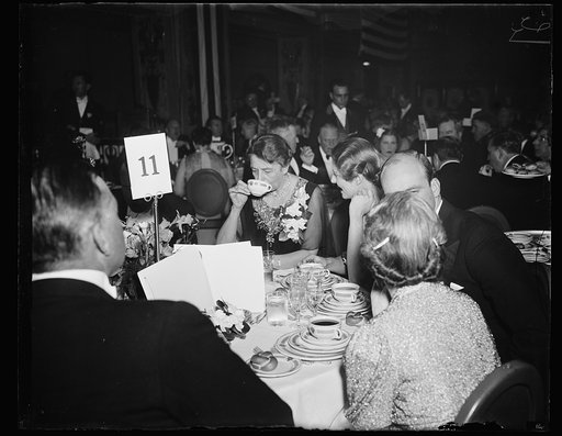 FIRST LADY ATTENDS FARLEY DINNER. WASHINGTON, D.C. FEBRUARY 16. MRS. FRANKLIN D. ROOSEVELT SEEMS TO BE ENJOYING THE CONSOMME AT THE TESTIMONIAL DINNER GIVEN TO JAMES A FARLEY LAST NIGHT. DEMOCRATS FROM EVERY STATE IN THE UNION ATTENDED THE AFFAIR
