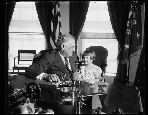 PRESIDENT RECEIVES FIRST BUDDY POPPY. WASHINGTON, D.C., APRIL 6. TODAY WAS HAPPY ONE FOR LITTLE FOUR-YEAR-OLD RUTH JOYCE BRADISH AS SHE PINNED THE FIRST BUDDY POPPY OF 1937 ON PRESIDENT ROOSEVELT AT THE WHITE HOUSE. THE SALE OF BUDDY POPPIES IS CONDUCTED ANNUALLY DURING THE WEEK OF MEMORIAL DAY BY T