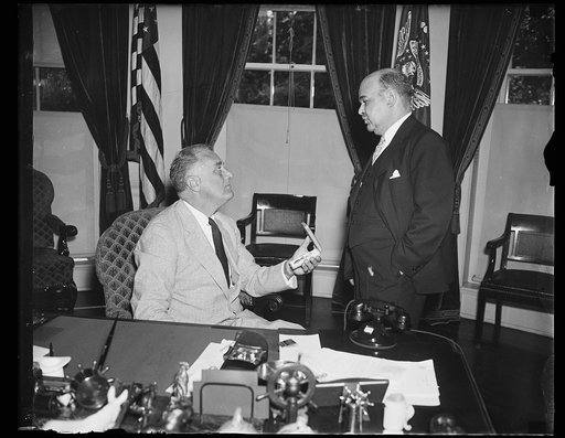 PRESIDENT BECOMES HEAD OF AMERICAN CROSS OF HONOR SOCIETY. WASHINGTON, D.C. JUNE 23. PRESIDENT ROOSEVELT TODAY BECAME HONORARY HEAD OF THE AMERICAN CROSS OF HONOR SOCIETY AND IS SHOWN RECEIVING AN HONORARY LIFE-SAVING MEDAL OF THE ORGANIZATION FROM RICHARD STOCKTON, NEWARK, NJ, SOCIETY PRESIDENT