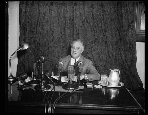 ROOSEVELT OFFERS RECOVERY PLAN. WASHINGTON, D.C. OCTOBER 12. PRESIDENT ROOSEVELT TONIGHT PROMISED TO CONTINUE TO STRIVE FOR PEACE AND ADVANCED A VAST LEGISLATIVE PROGRAM FOR THE SPECIAL SESSION OF CONGRESS HE CALLED LATE TODAY TO CONVENE NOVEMBER 15TH. THE PRESIDENT IS SHOWN JUST BEFORE MAKING HIS N