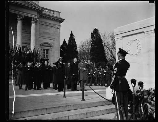 PRESIDENT PAYS TRIBUTE TO UNKNOWN SOLDIER. PRESIDENT ROOSEVELT TODAY LEAD THE NATION IN OBSERVING ARMISTICE DAY WHEN HE PLACED A WREATH ON THE TOMB OF THE UNKNOWN SOLDIER IN ARLINGTON. FLANKED BY HIS MILITARY AND NAVAL AIDES CAPT. WALTER B. WOODSON AND COLE. D. WATSON, PRESIDENT ROOSEVELT STOOD IN S