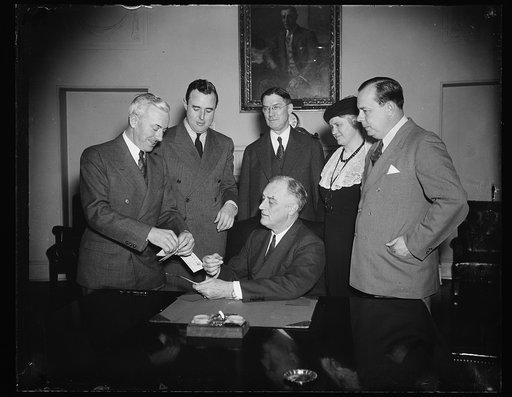 PRESIDENT ENROLLED AS 'FOUNDER' IN FOUNDATION FOR INFANTILE PARALYSIS. WASHINGTON, D.C. JANUARY 17. PRESIDENT ROOSEVELT TODAY PURCHASING FROM U.S. SURGEON GENERAL THOMAS PARRAN A CERTIFICATE ENROLLING HIM AS A 'FOUNDER' OF THE NATIONAL FOUNDATION FOR INFANTILE PARALYSIS. THE NEW FOUNDATION, A PERMAN