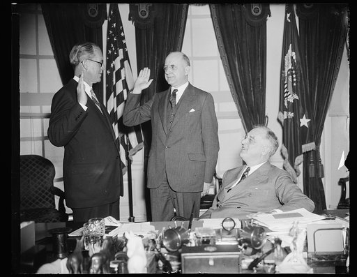 TAKES OATH AS U.S. ENVOY TO GREAT BRITAIN, WASHINGTON, D.C., FEBRUARY 18. WITH PRESIDENT ROOSEVELT AS AN INTERESTED WITNESS, JOSEPH P. KENNEDY, FORMER U.S. MARITIME COMMISSION CHAIRMAN, TODAY WAS SWORN IN AS U.S. ENVOY TO GREAT BRITAIN BY ASSOCIATE SUPREME COURT JUSTICE STANLEY F. REED. KENNEDY TEND