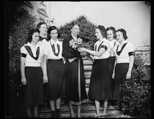 CAMPFIRE GIRLS GREET MRS. ROOSEVELT  Washington, DC. April 13. Mrs. Franklin D. Roosevelt, Honorary Chairman of the Camp Fire Girls Advisory Council, was hostess at tea for the girls who are in Washington on their annual convention, she was presented with a bouquet of flowers on the steps of the Whi