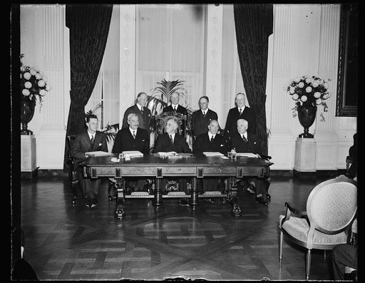 U.S.-GREAT BRITAIN-CANADA TRADE TREATY SIGNED AT WHITE HOUSE, WASHINGTON, D.C. NOVEMBER 17. THE HISTORIC EAST ROOM OF THE WHITE HOUSE WAS THE SCENE TODAY AS THE GREATEST TRADE TREATY IN RECENT HISTORY, EMBRACING A TOTAL AMERICAN TRADE OF 1,500,000,000 DOLLARS, WAS SIGNED BY PRESIDENT ROOSEVELT, BRIT