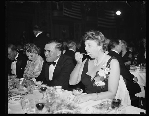 PRESIDENT'S WIFE CAME AS A GUEST. WASHINGTON, D.C. JANUARY 7. MRS. FRANKLIN D. ROOSEVELT CAME TO THE JACKSON DAY DINNER HERE, BUT DIDN'T TAKE PART. SHE SAT NEAR THE PRESIDENT'S PLACE, BUT NOT ON THE SPEAKER'S TABLE. HERE SHE IS PUTTING AWAY PART OF HER $100 DINNER