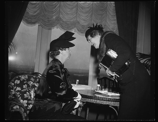 FIRST LADY AND A PROBABLE ONE. WASHINGTON, D.C. JANUARY 10. MRS. FRANKLIN D. ROOSEVELT, LEFT, CHATS INFORMALLY WITH MRS. ARTHUR M. VANDENBERG, WIFE OF THE REPUBLICAN SENATOR FROM MICHIGAN, AS BOTH ATTENDED THE FIRST LUNCHEON OF THIS CONGRESS OF THE SENATE LADIES LUNCHEON CLUB TODAY. MRS. GARNER, WIF