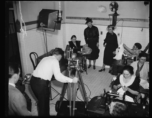 Movies record visit of First lady and wife of Treasury Secretary to self help exchange. Washington, D.C., February 9.  When Mrs. Franklin D. Roosevelt and Mrs. Henry Morgenthau today visited the self-help exchange here, movie news cameras were on hand. Facing the movie photographer are Mrs. Morgenth