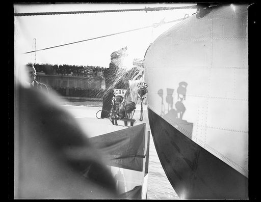FIRST LADY CHRISTENS YANKEE CLIPPER. WASHINGTON, D.C. MARCH 3. MRS. ROOSEVELT TODAY SMASHED A BOTTLE OF WATER FROM THE SEVEN SEAS ON THE BOW OF THE YANKEE CLIPPER, CHRISTENING THE 40-TON, 74 PASSENGER FLYING BOAT WHICH WILL INAUGURATE TRANSATLANTIC AIR PASSENGER SERVICE. THE CEREMONY TOOK PLACE AT T