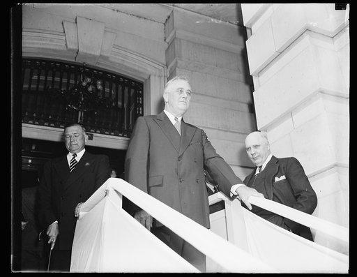 PRESIDENT LEAVES CAPITOL AFTER ADDRESS. WASHINGTON, D.C. SEPTEMBER 21. PRESIDENT ROOSEVELT, FOLLOWING HIS ADDRESS TO THE JOINT SESSION OF CONGRESS TODAY, IS SHOWN HERE AS HE LEFT THE CAPITOL. ON THE LEFT IS BRIG. GENL. EDWIN M. WATSON, SECRETARY TO THE PRESIDENT; AND ON THE RIGHT IS KENNETH ROMNEY, 