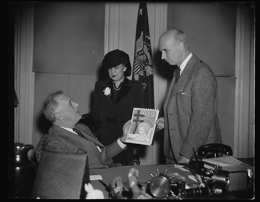 PRESIDENT BUYS ANNUAL SUPPLY OF XMAS SEALS. WASHINGTON, D.C. NOVEMBER 20. PRESIDENT ROOSEVELT BUYS HIS ANNUAL SUPPLY OF CHRISTMAS SEALS FROM ROCKWELL KENT, FAMOUS ARTIST AND AUTHOR. WHILE MRS. ERNEST GRANT, DISTRICT OF THE D.C. TUBERCULOSIS ASSOCIATION LOOKS ON. THIS WAS THE SIGNAL FOR THE OPENING O