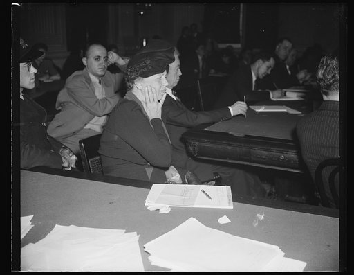 FIRST LADY ATTENDS DIES HEARING FOR THIRD TIME. WASHINGTON, D.C. DECEMBER 1. ATTENDING THE DIES HEARING TODAY FOR THE THIRD TIME, MRS. ROOSEVELT APPEARS INTENTLY INTERESTED AS SHE LISTENS TO THE TESTIMONY OF JOSEPH P. LASH, EXECUTIVE SECRETARY OF THE AAMERICAN STUDENT'S UNION