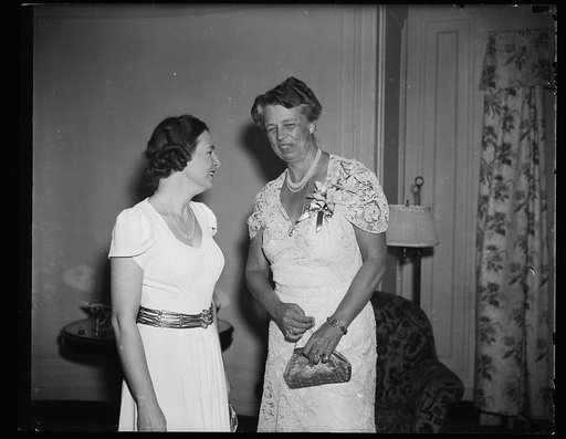 FIRST LADY TALKS TO WIFE OF G.O.P. CANDIDATE. WASHINGTON, D.C. MARCH 11. WHEN MRS. FRANKLIN D. ROOSEVELT FINISHED TALKING TO MRS. THOMAS E. DEWEY, SHE SMILED TO NEWSPAPERWOMEN PRESENT AND SAID, 'WOULDN'T YOU LIKE TO KNOW WHAT WE SAID?' THE PHOTOGRAPH WAS TAKEN AT SATURDAY NIGHT'S STUNT PARTY BY THE 