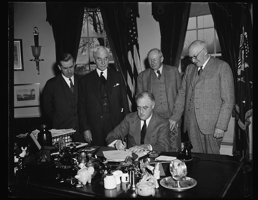 PRESIDENT SIGNS BILL EXTENDING RECIPROCAL TRADE PROGRAM. WASHINGTON, D.C. APRIL 12. PRESIDENT ROOSEVELT PICTURED SIGNING TODAY THE BILL EXTENDING FOR THREE YEARS THE POWER OF THE UNITED STATES TO NEGOTIATE RECIPROCAL TRADE TREATIES WITH FOREIGN POWERS. DIRECTLY BACK OF THE PRESIDENT, L TO R: SECRETA