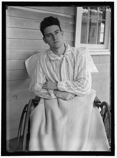 Young veteran soldier in wheelchair on porch, Walter Reed Hospital, Washington, D.C.