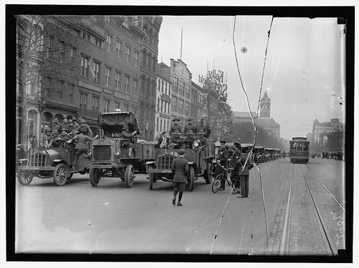 ARMY, U.S. SOLDIERS GOING THROUGH CITY IN TRUCKS AND AUTOS