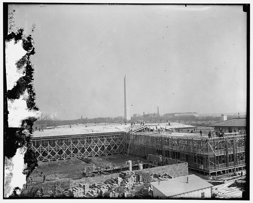 Temporary building, under construction, built in 1917, for the war. Washington monument in background. Located between B Street (now Constitution Ave.), 19th Street, Virginia Ave., and 18th Street, N.W., Washington, D.C.