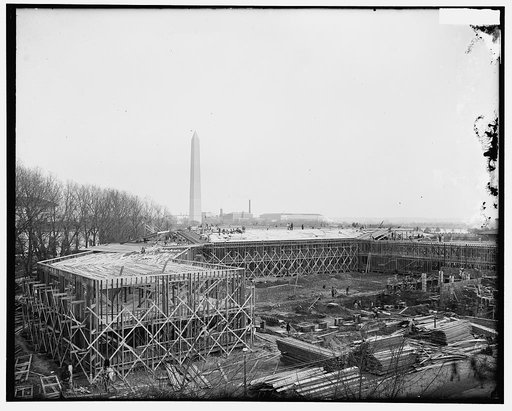 Temporary building under construction, built in 1917, for the war.  View looking east northeast with Washington Monument in background, and buildings of the Bureau of Engraving and Printing in right distance. Located between B Street (now Constitution Ave.), 19th Street, Virginia Ave., and 18th Stre