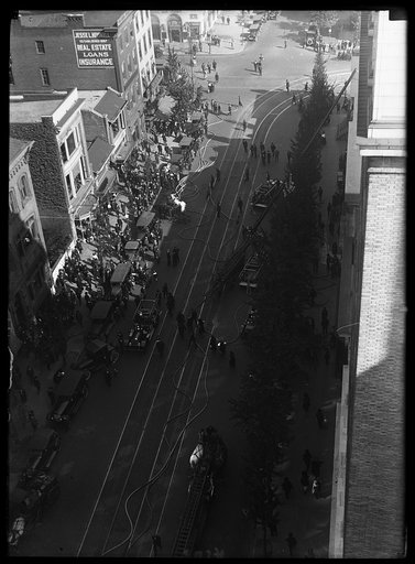 View of firetrucks and equipment on street from rooftop. Washington, D.C.