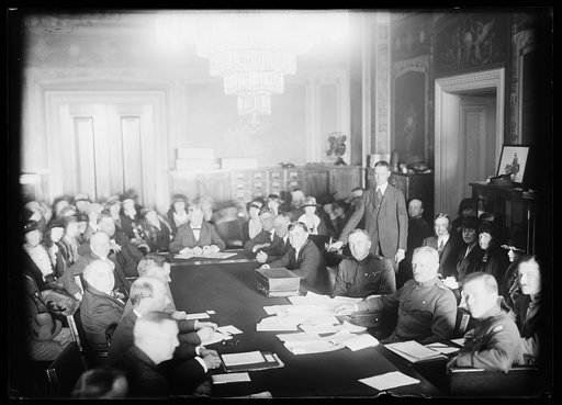 Group at table; includes John J. Pershing, 3rd from right