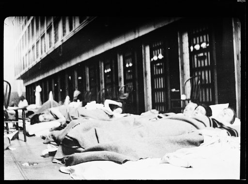 Women sleeping on sidewalk