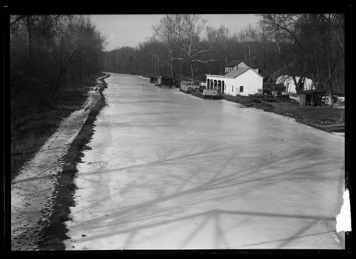 Buildings next to frozen canal