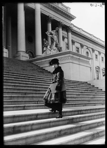 Woman ascending steps of U.S. Capitol, Washington, D.C.