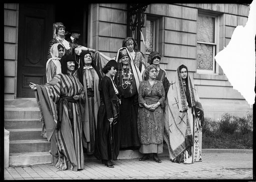 Group in costume on steps; sign: "League of American Pen Women, Authors' Carnival and Ball ... Book Fair ... Massachusetts Ave. [Washington, D.C.