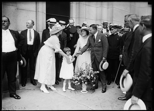 James M. Cox with hand extended