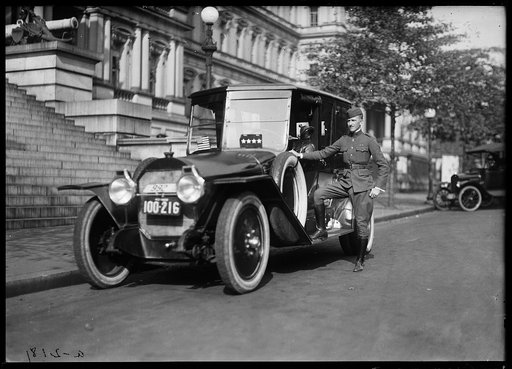 Man with automobile in front of State, War and Navy Building, Washington, D.C.